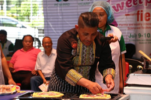 Sweetpotato Pizza. Chef Pablo “Boy” Logro adds ham, among other ingredients, to the sweetpotato pizza. (Image credit: Kathleen Princess Aldama, Applied Communication Division (ACD), PCAARRD)